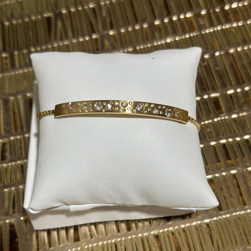 Gold Michael Kors bracelet with bolo closure